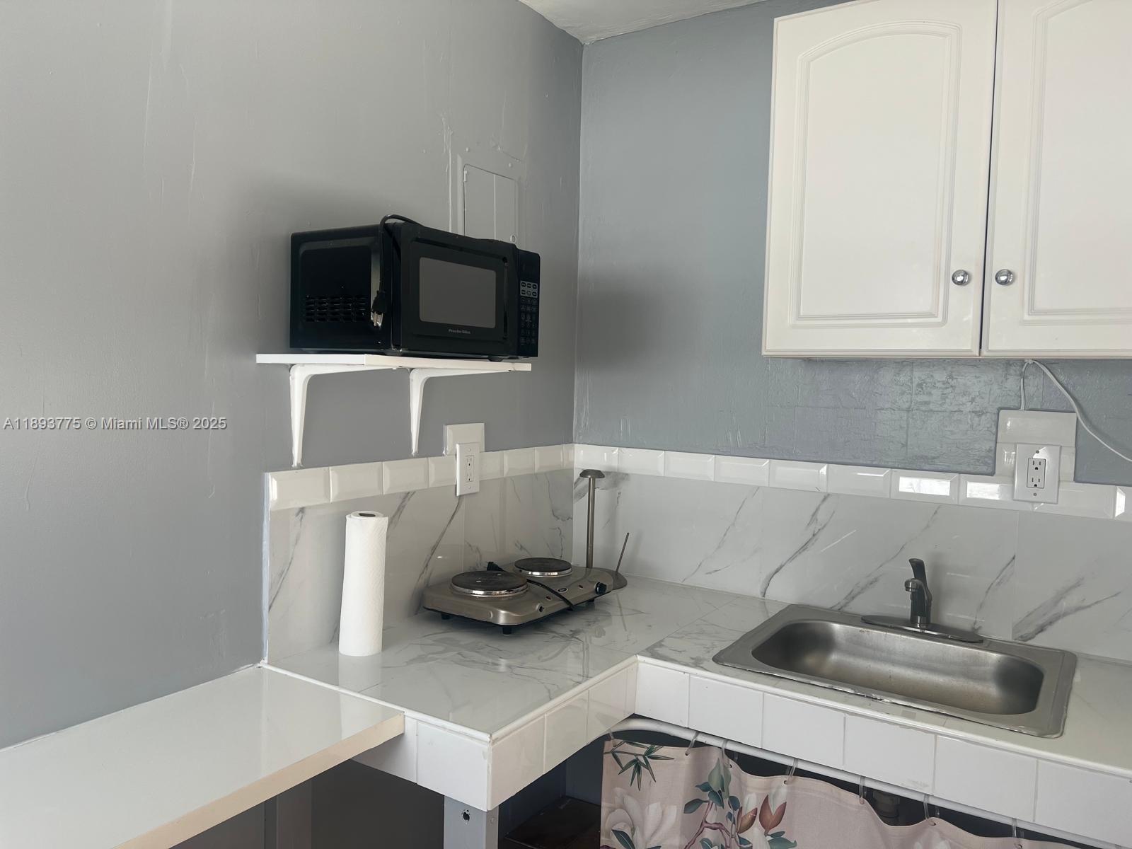 4361 Southwest 3rd Street, Unit 1 Miami, FL 33134 - Photo 8 of 11 a utility room with sink dryer and washer