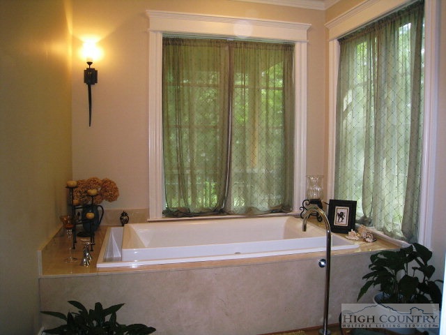 500 Manor Ridge Boone, NC 28607 - Photo 4 of 17 a bath tub sitting in a bathroom next to a window