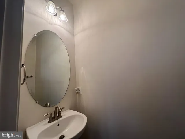 a bathroom with a sink and mirror