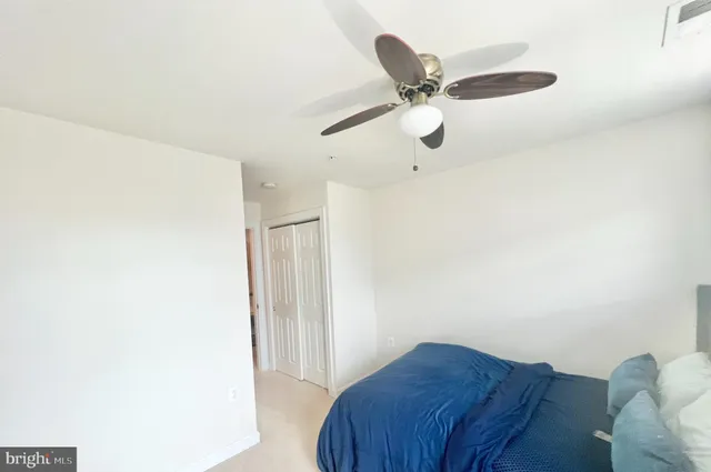 a view of a livingroom with a ceiling fan and wooden floor