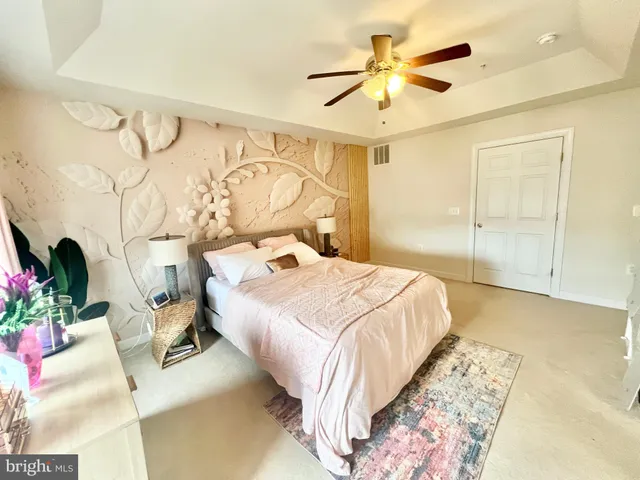 a white bath tub sitting in a bathroom next to a window