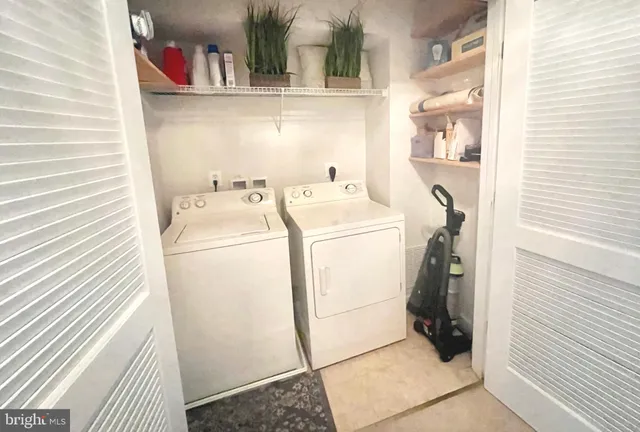 a front view of a residential apartment building with a yard and parking space