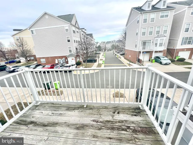 a view of a house with pool and trees in the background