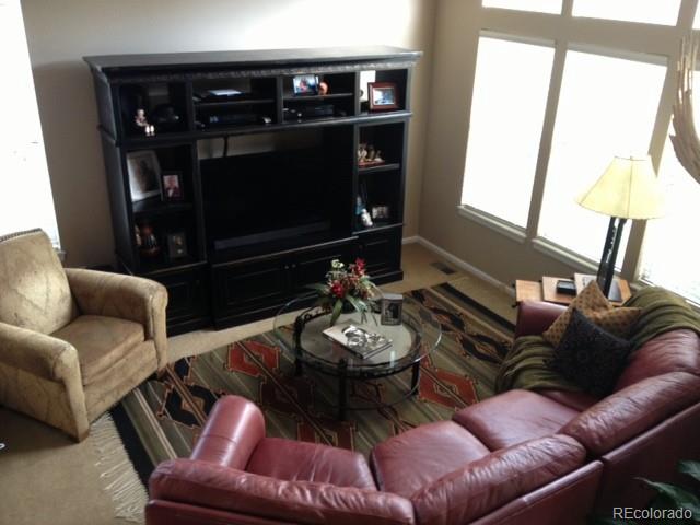 a living room with furniture a window and a fireplace