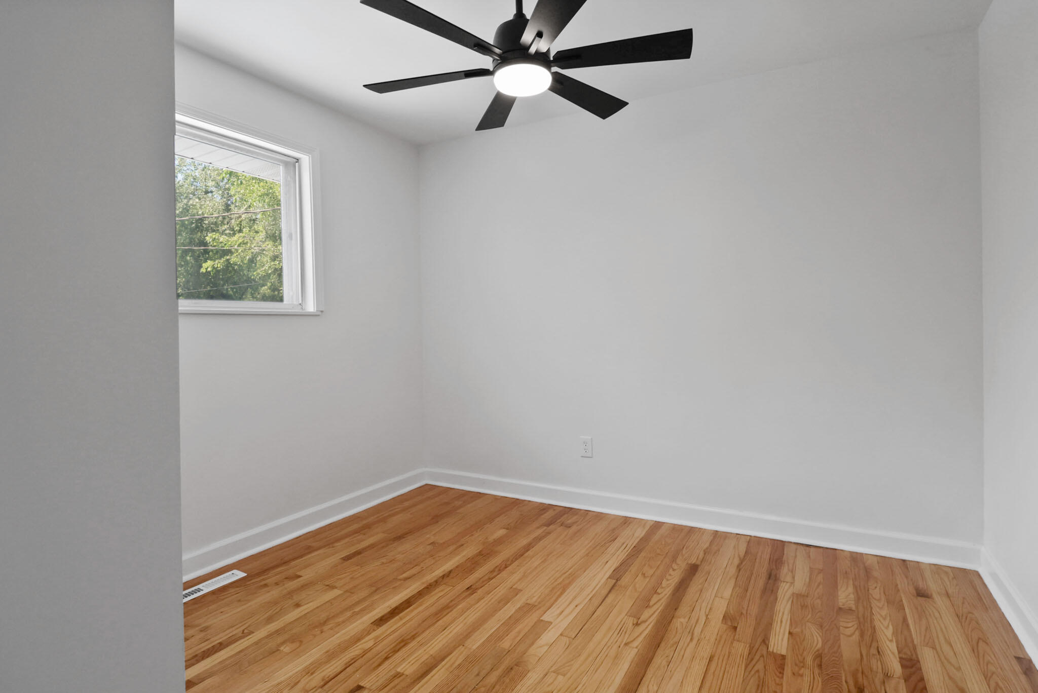 1564 Clinton Street Gary, IN 46406 - Photo 13 of 27 an empty room with a window and a ceiling fan