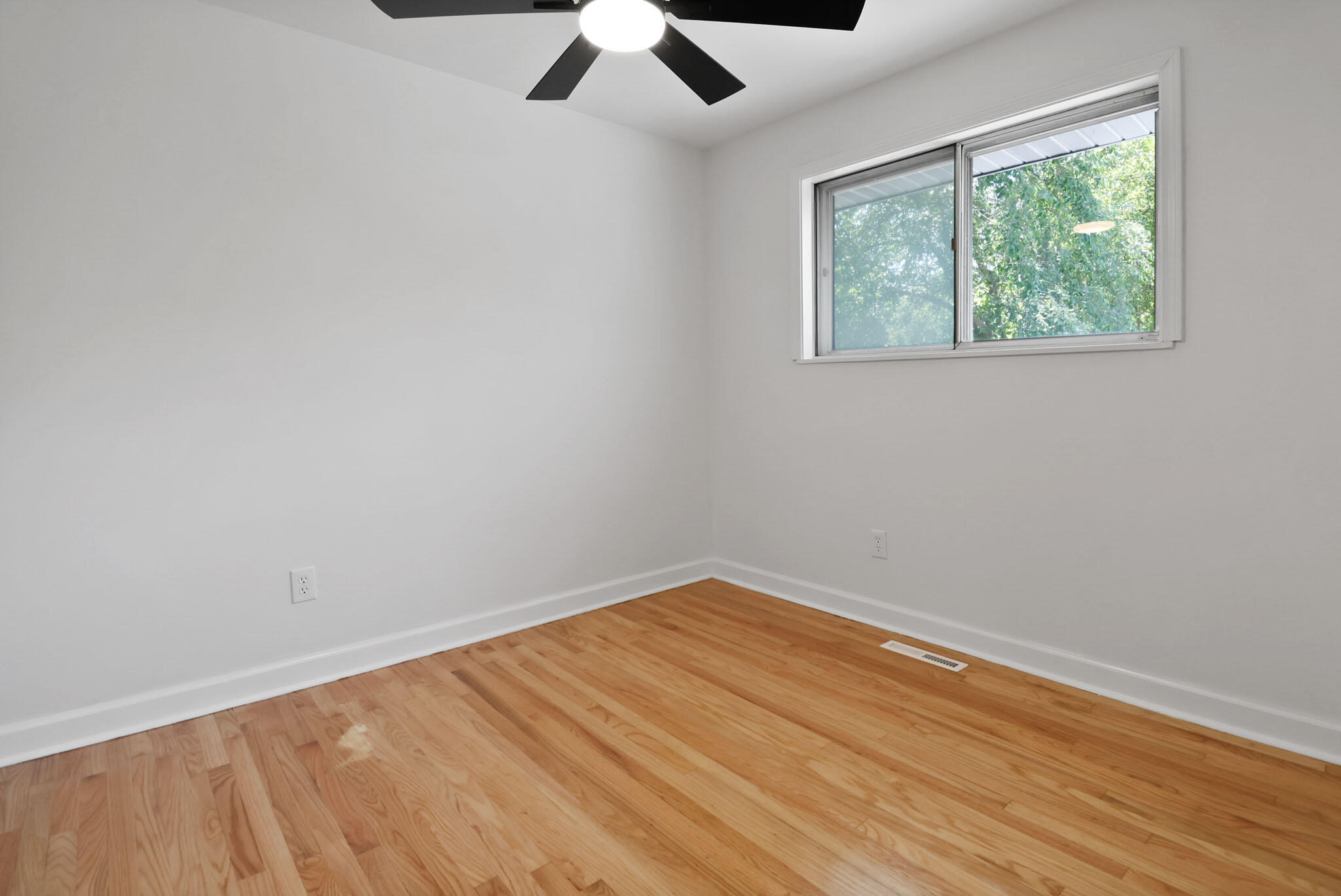1564 Clinton Street Gary, IN 46406 - Photo 15 of 27 wooden floor in an empty room with a window