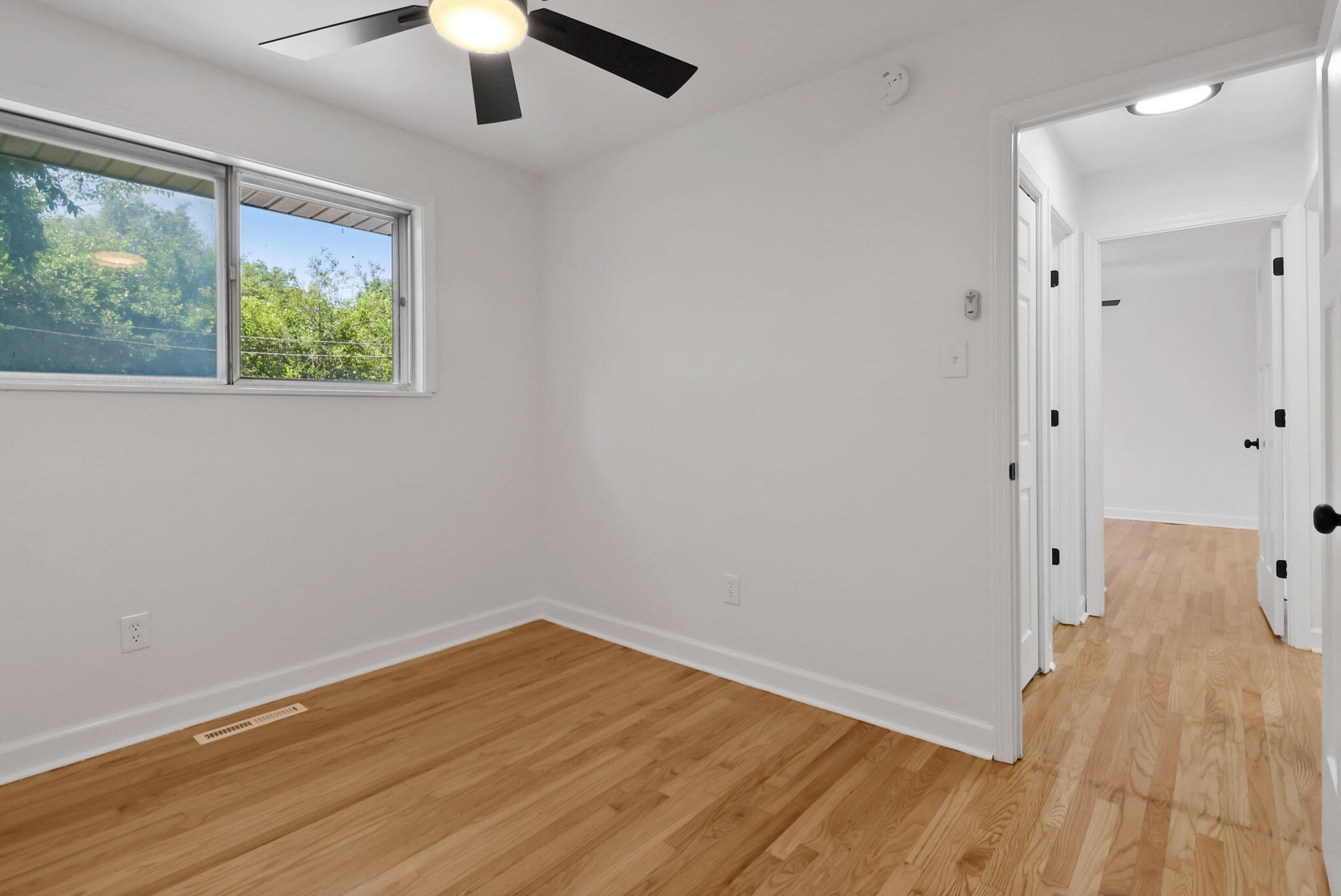 1564 Clinton Street Gary, IN 46406 - Photo 16 of 27 wooden floor in an empty room with a window