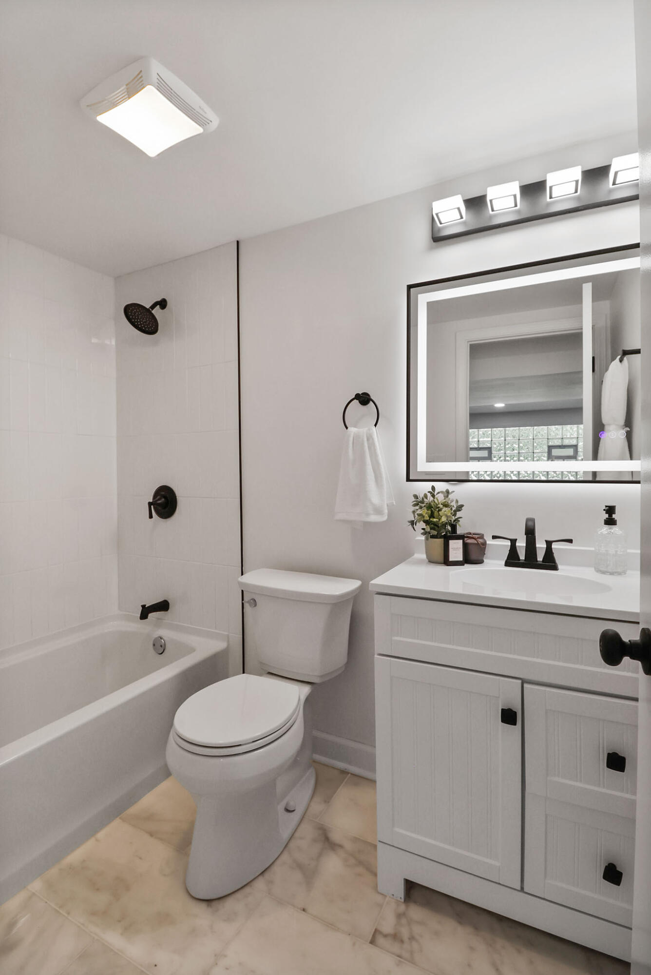 1564 Clinton Street Gary, IN 46406 - Photo 19 of 27 a bathroom with a toilet sink a mirror and bathtub