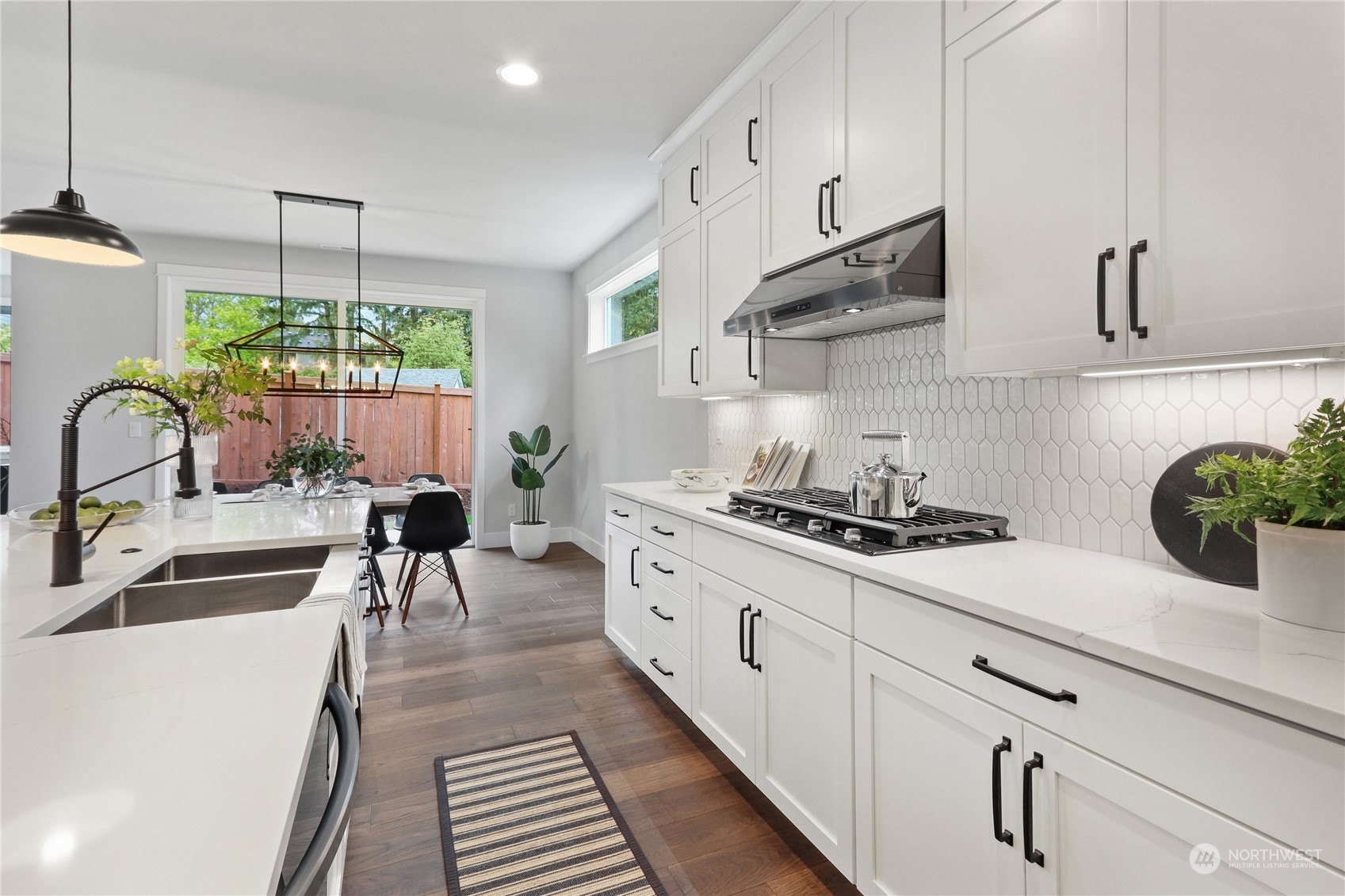 3904 211th Place Southeast Bothell, WA 98021 - Photo 12 of 24 a kitchen with stainless steel appliances a stove a sink and white cabinets
