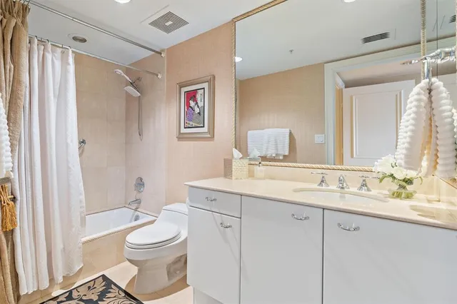 a bathroom with a granite countertop sink toilet a large mirror a vanity and shower