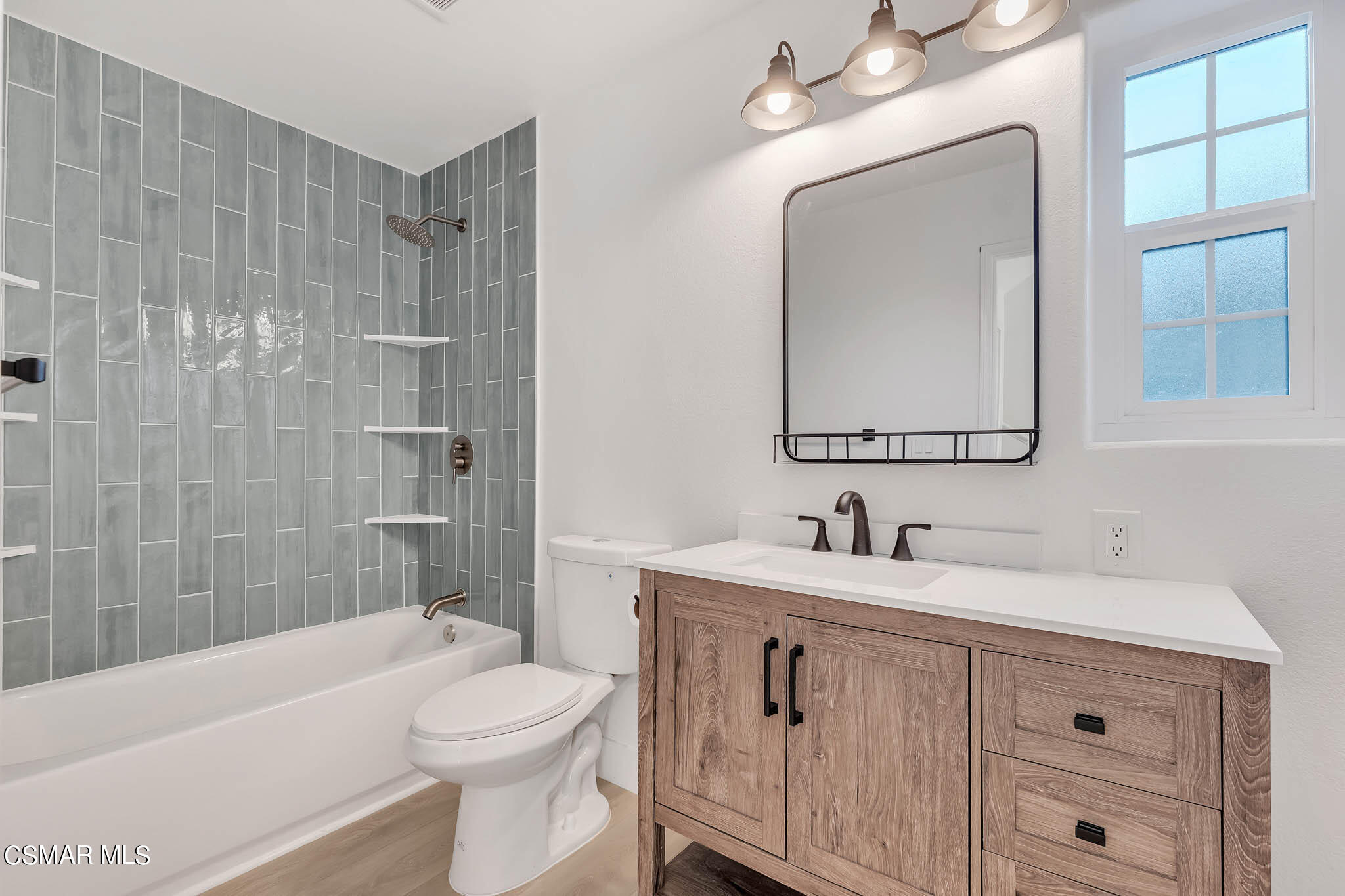 5222 West Wooley Road Oxnard, CA 93035 - Photo 20 of 39 a bathroom with a toilet a sink a tub and mirror