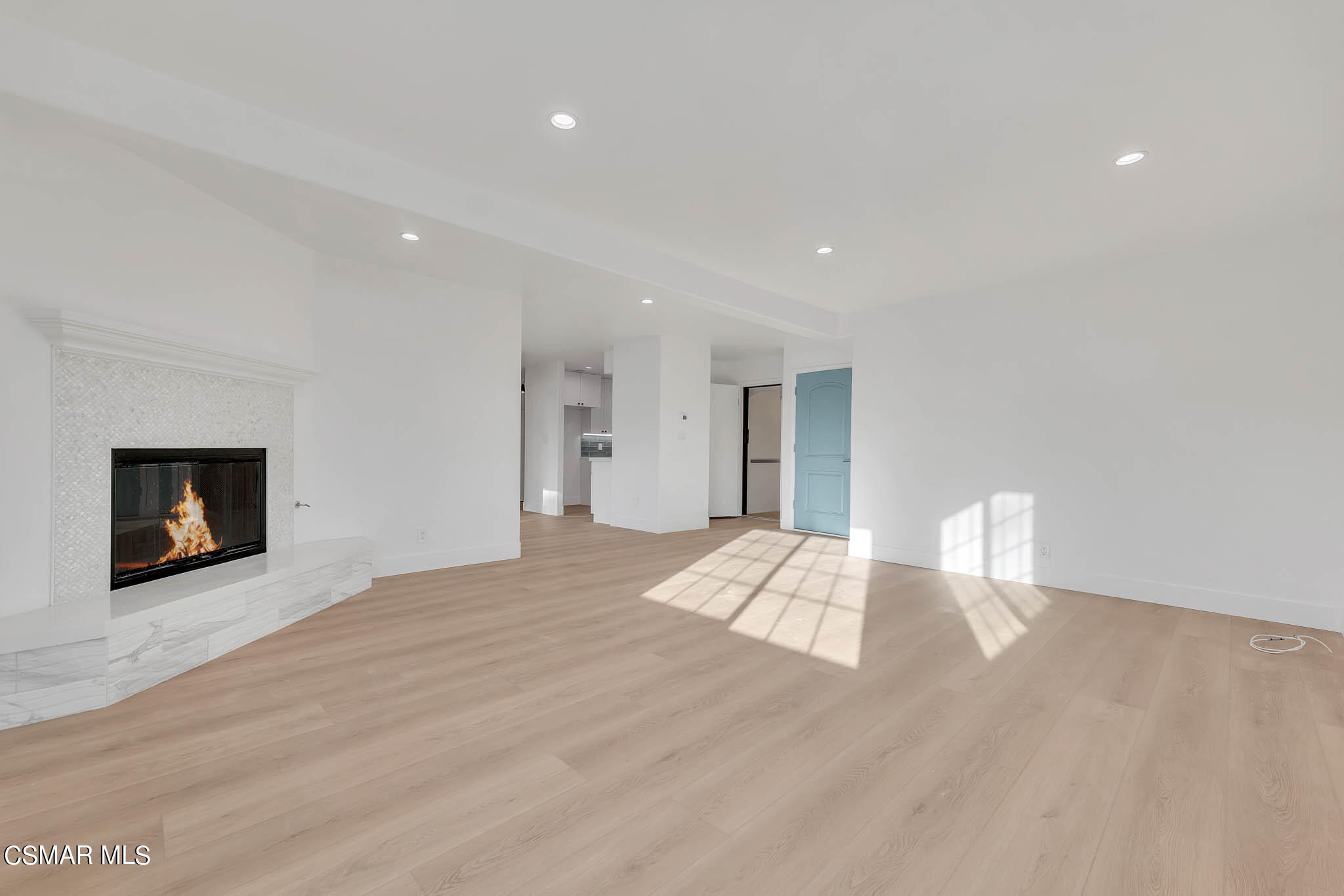 5222 West Wooley Road Oxnard, CA 93035 - Photo 8 of 39 a view of empty room with wooden floor and fireplace