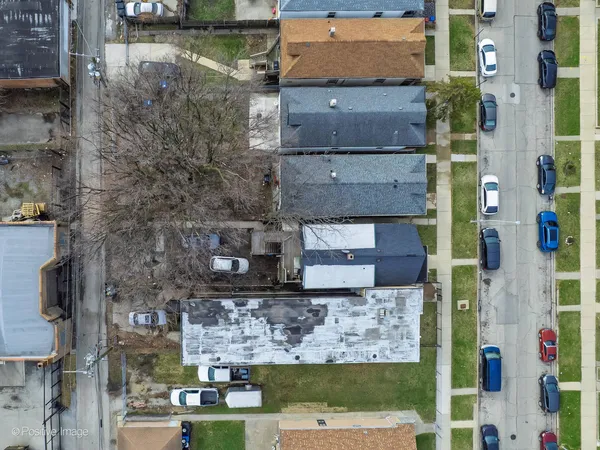 an aerial view of residential houses with outdoor space