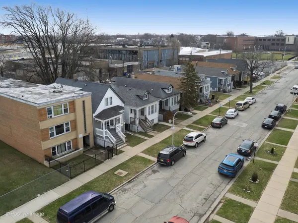 an aerial view of multiple houses with yard