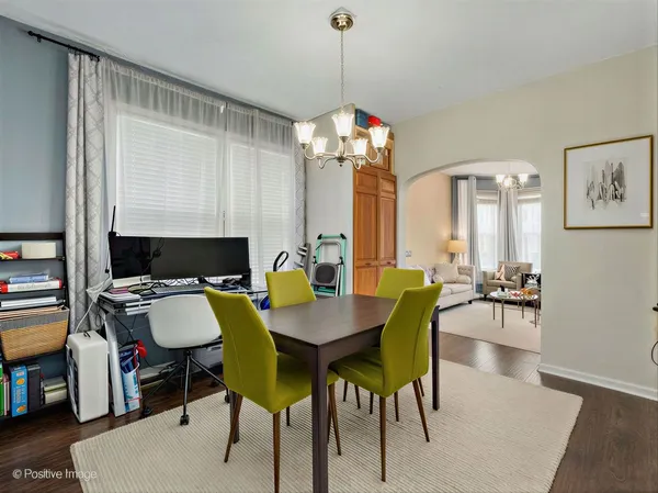 a view of a dining room with furniture and a chandelier
