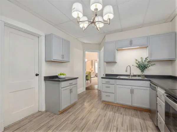 a kitchen with stainless steel appliances granite countertop a lot of counter top space and cabinets