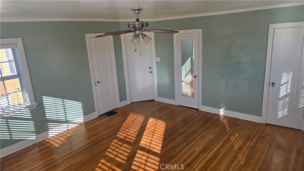 6179 Oak Crest Way Los Angeles, CA 90042 - Photo 2 of 5 a view of an empty room with wooden floor and a window