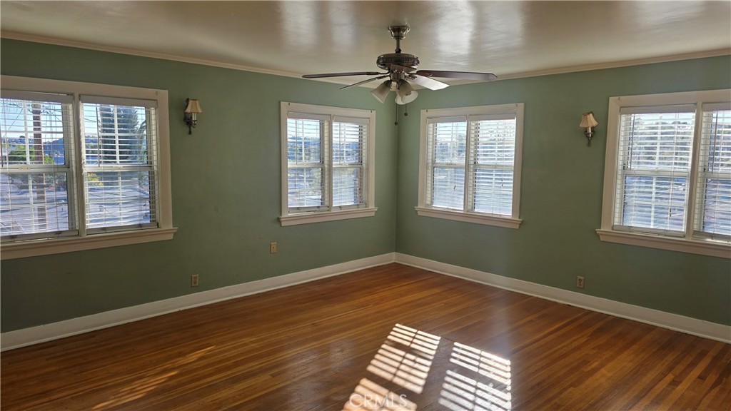 6179 Oak Crest Way Los Angeles, CA 90042 - Photo 3 of 5 a view of empty room with wooden floor and fan