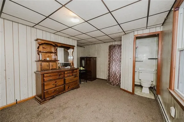 a view of an empty room with closet and racks