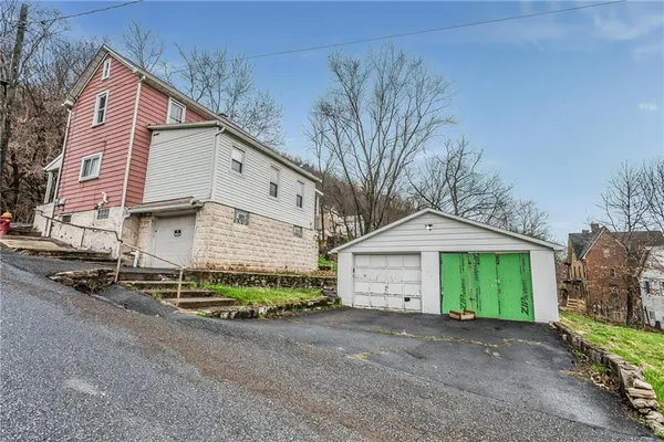 a view of a house with a yard and garage