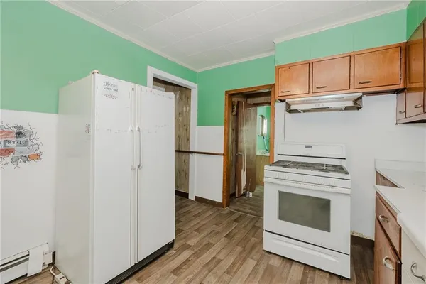 a kitchen with stainless steel appliances white cabinets and a refrigerator