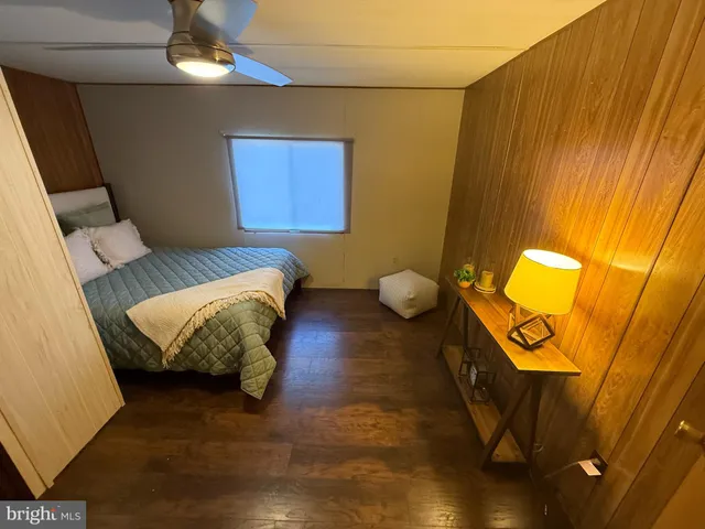 a living room with a couch and a bookshelf