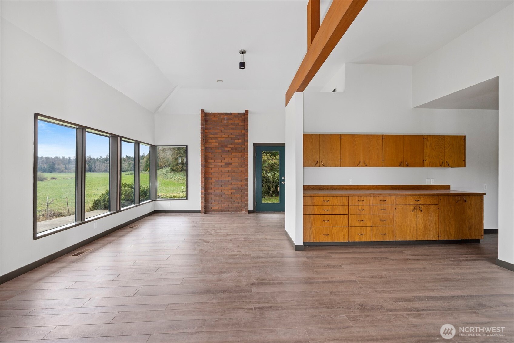 18928 Bow Hill Road Burlington, WA 98233 - Photo 11 of 39 a view of an empty room with wooden floor and windows