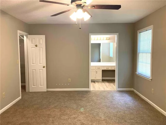 a view of a hallway with a livingroom and a window