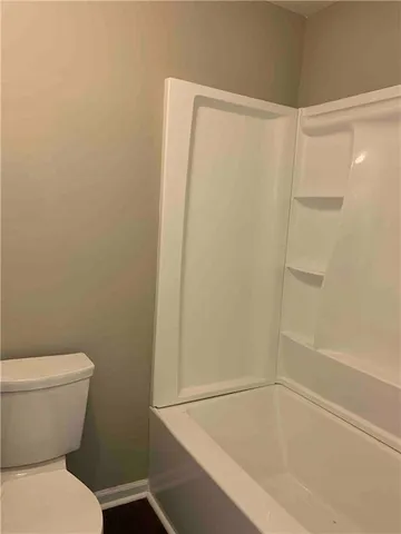 a bathroom with a shower and a toilet