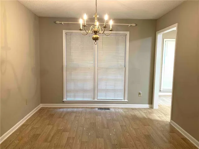 a view of a livingroom with a chandelier fan