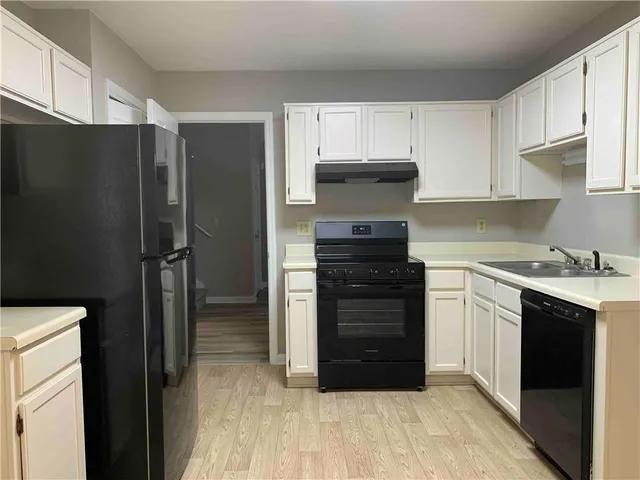 a kitchen with a refrigerator and a stove