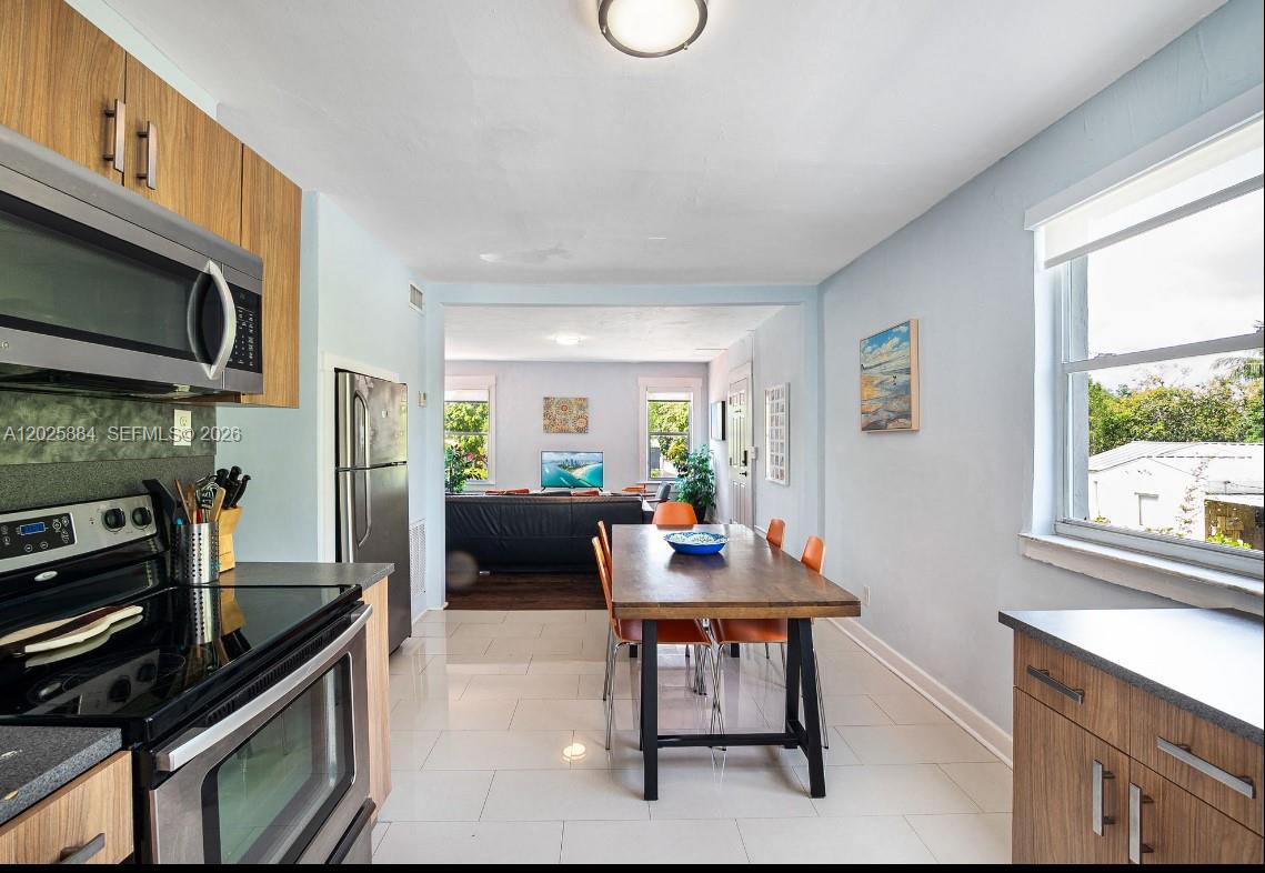 2255 Southwest 10th Street, Unit B Miami, FL 33135 - Photo 21 of 26 a living room with furniture a fireplace a flat screen tv and a window
