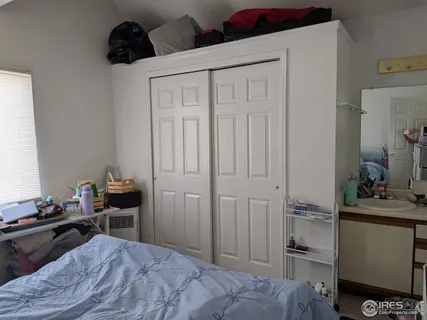 a bedroom with a bed and a chair