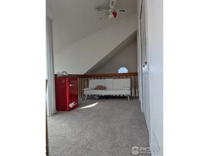 a view of a room with furniture and a window