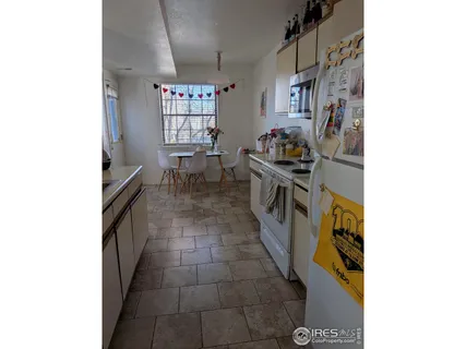 a kitchen with granite countertop a stove and cabinets