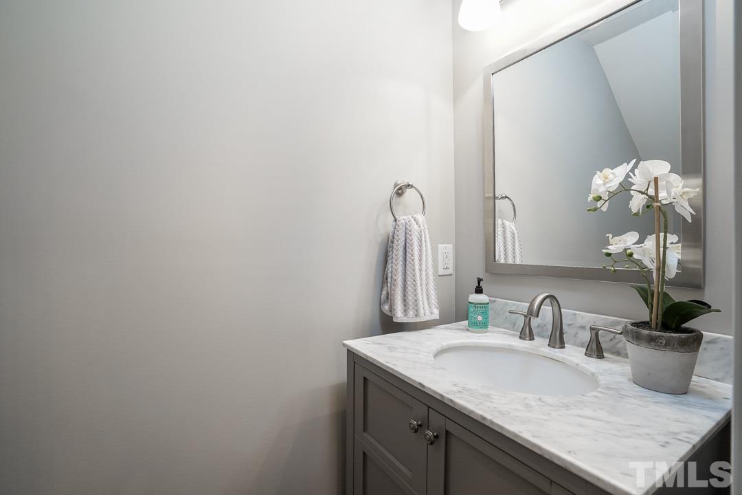 1318 Springlawn Court Raleigh, NC 27609 - Photo 11 of 30 a bathroom with a granite countertop sink and a mirror