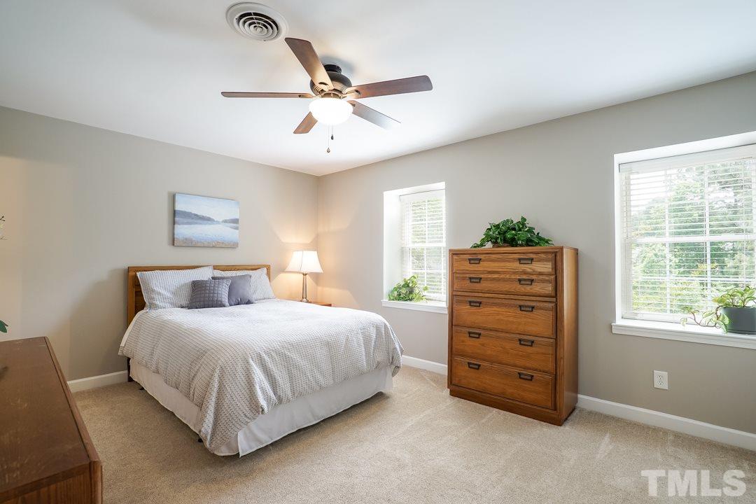 1318 Springlawn Court Raleigh, NC 27609 - Photo 15 of 30 a bedroom with a bed dresser and a window