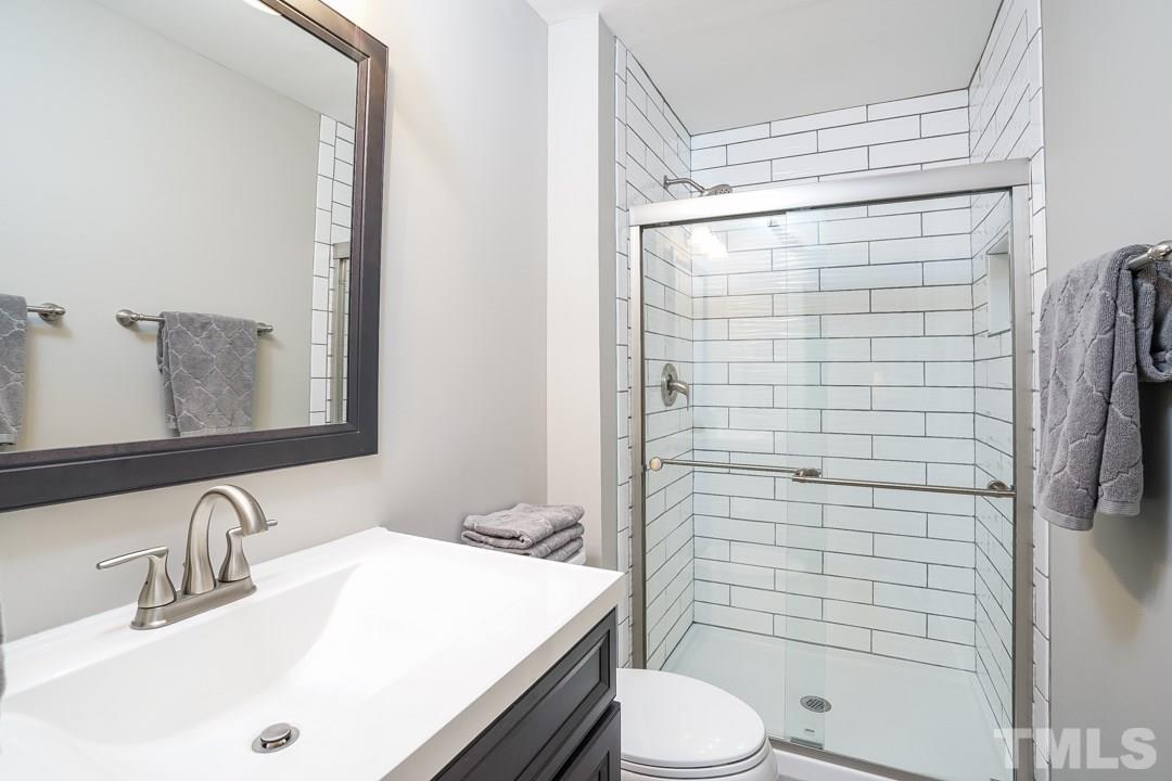 1318 Springlawn Court Raleigh, NC 27609 - Photo 17 of 30 a bathroom with a sink a toilet and shower