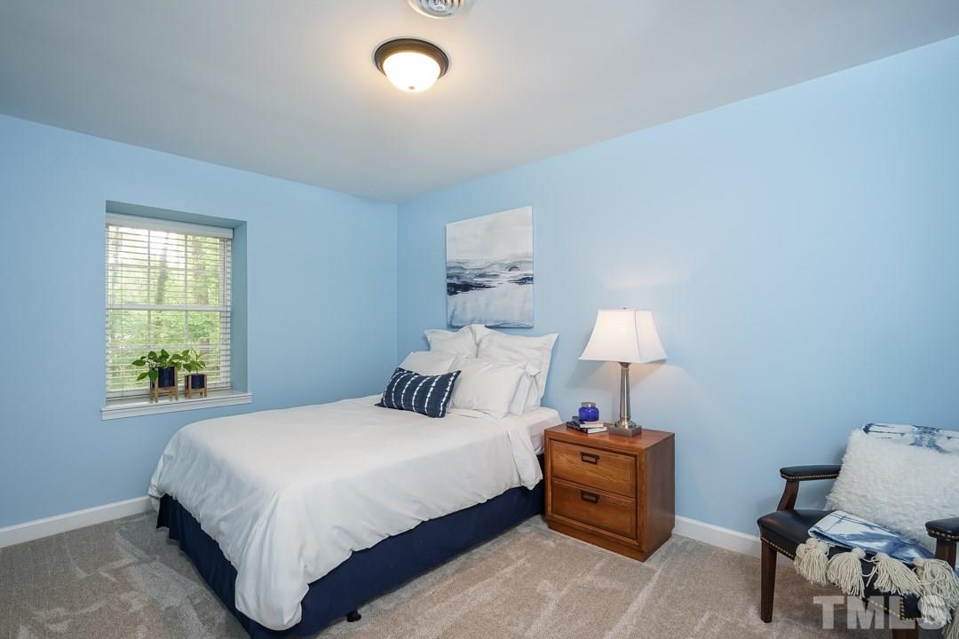1318 Springlawn Court Raleigh, NC 27609 - Photo 18 of 30 a bedroom with a bed and a window