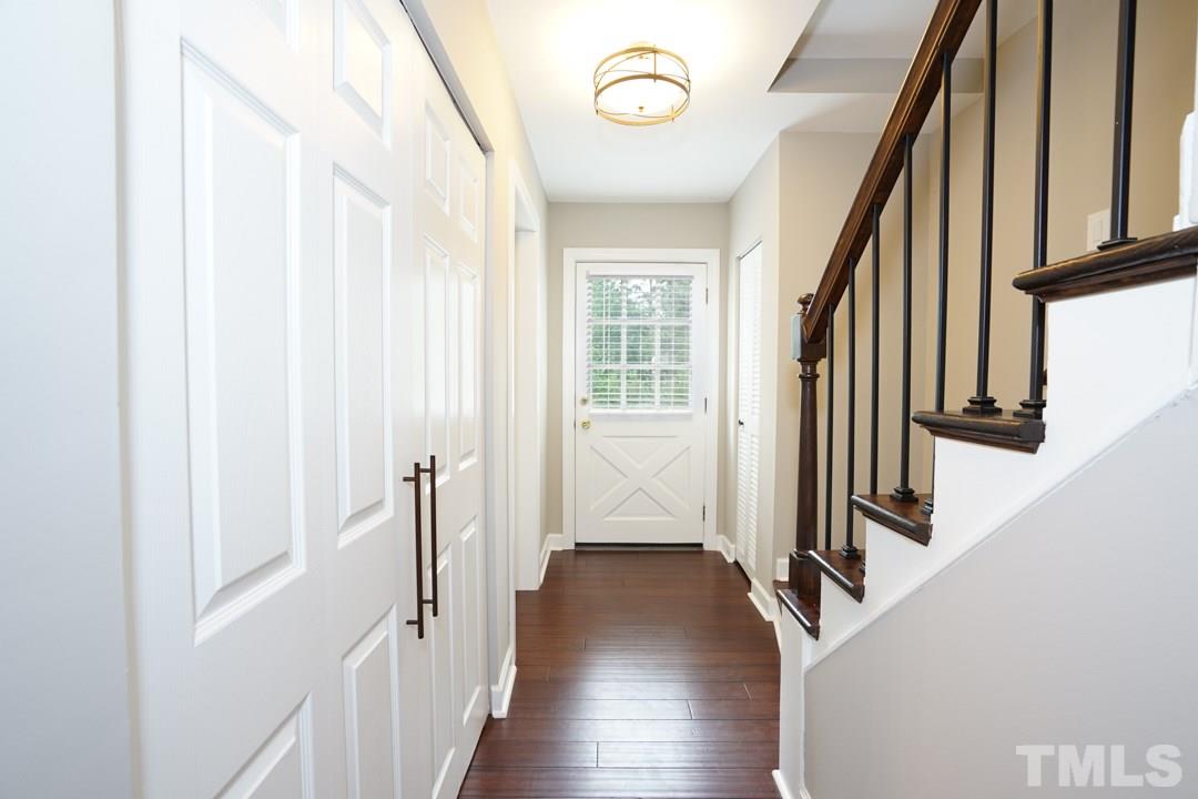 1318 Springlawn Court Raleigh, NC 27609 - Photo 3 of 30 a view of a hallway with wooden floor and staircase