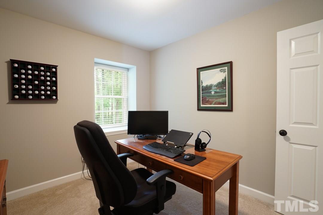 1318 Springlawn Court Raleigh, NC 27609 - Photo 21 of 30 a view of a workspace with furniture and a window