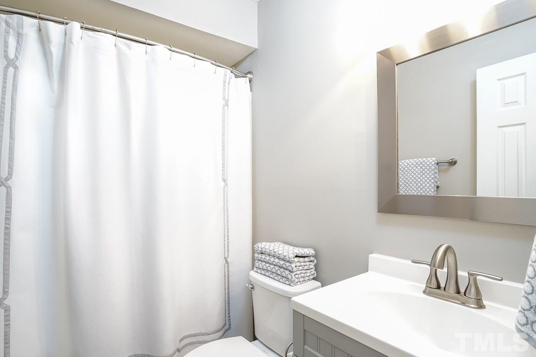 1318 Springlawn Court Raleigh, NC 27609 - Photo 22 of 30 a bathroom with a sink and a toilet
