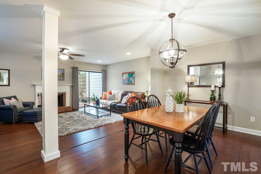 1318 Springlawn Court Raleigh, NC 27609 - Photo 30 of 30 a view of a dining room and livingroom with furniture wooden floor a chandelier