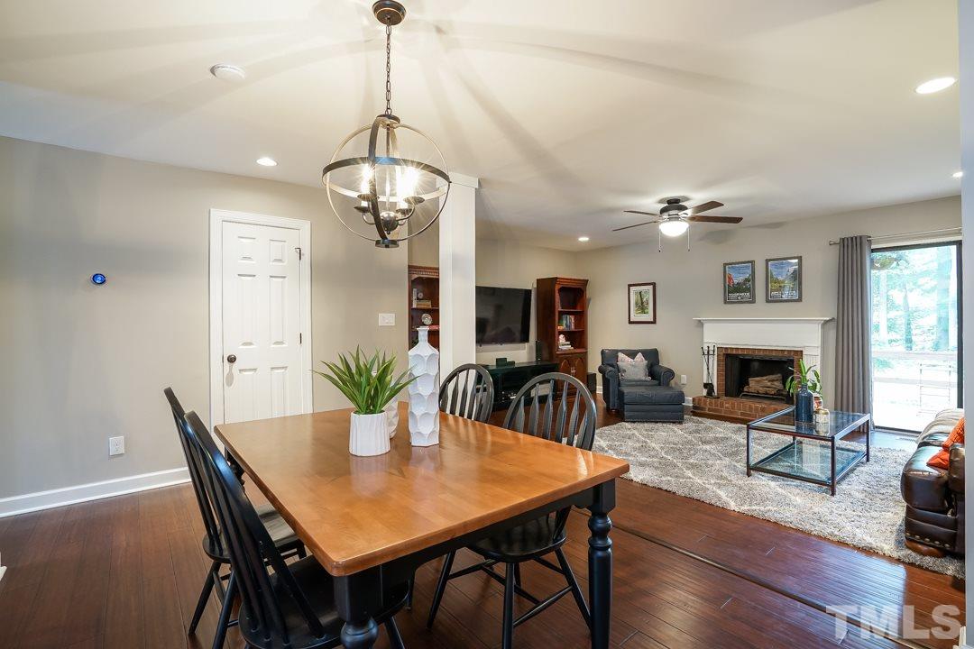 1318 Springlawn Court Raleigh, NC 27609 - Photo 4 of 30 a view of a dining room with furniture a livingroom and chandelier