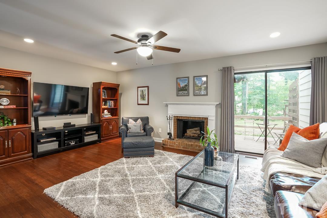 1318 Springlawn Court Raleigh, NC 27609 - Photo 5 of 30 a living room with furniture fireplace and flat screen tv