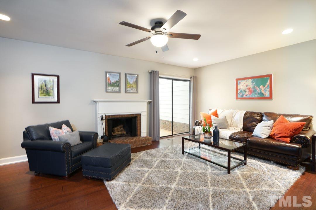 1318 Springlawn Court Raleigh, NC 27609 - Photo 6 of 30 a living room with furniture and a fireplace