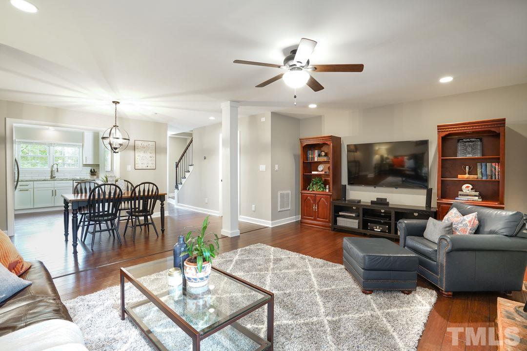 1318 Springlawn Court Raleigh, NC 27609 - Photo 7 of 30 a living room with furniture a dining table and a piano