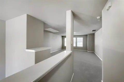 a view of hallway with wooden floor