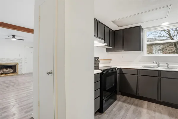a kitchen with stainless steel appliances a stove sink and cabinets