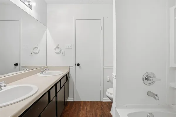 an empty room with chandelier fan